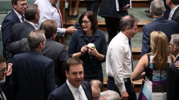 In hand: MP Sarah Henderson speaks to colleagues...with a cup of coffee in hand. 