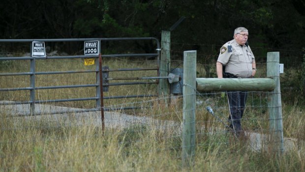 An officer guards the entrance where Devin Patrick Kelley lived in New Braunfels, Texas. 