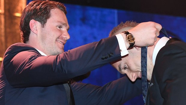 Patrick Dangerfield presents this year's Brownlow to Dustin Martin. 