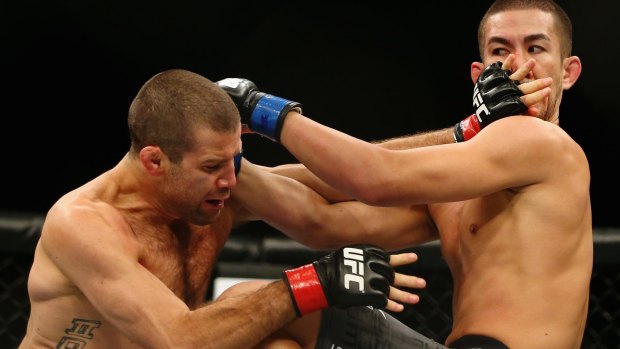 Anything goes: Richie Vaculik, left, cuts off  Louis Smolka's air during their UFC bout.
