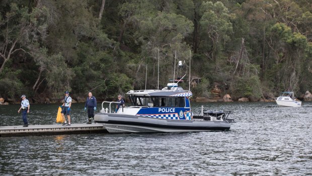 A police boat attends the scene of the crash.