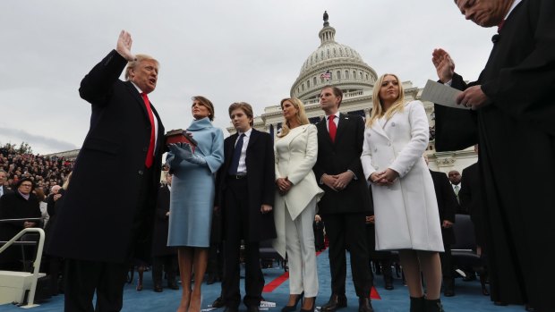 President Donald Trump takes the oath of office from Chief Justice John Roberts, as his wife Melania holds the Bible, and with his children Barron, Ivanka, Eric and Tiffany.
