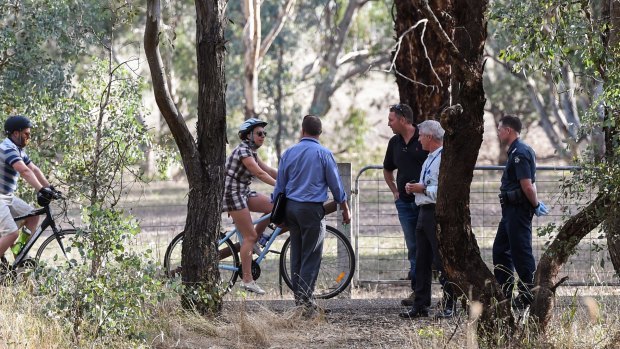 Police officers talk to other cyclists on the rail trail.