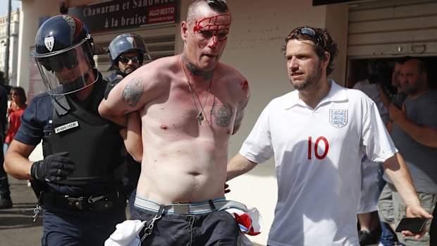 A man is arrested by police officers in downtown Marseille.