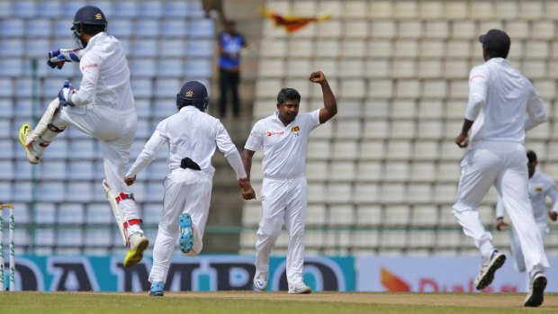 Captain's fall: Sri Lankan bowler Rangana Herath (second from right) and teammates celebrate the dismissal of Australia's Steve Smith.