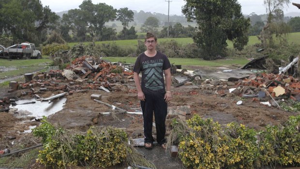 Keegan Jones in front of the debris of his house, which was washed away
by flood waters in Dungog.