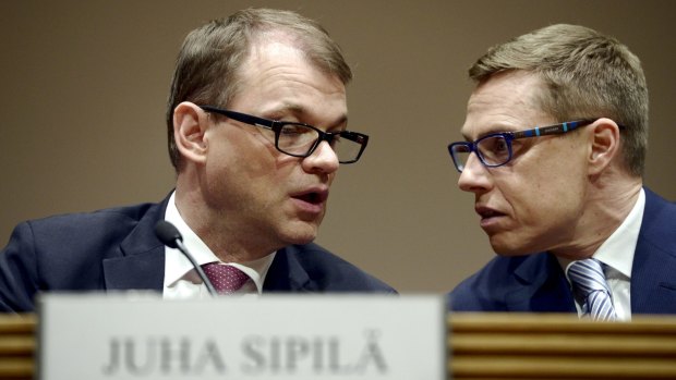 The victorious Juha Sipila with defeated Prime Minister Alexander Stubb on Sunday.