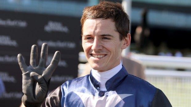 Rare feat: Jason Collett gestures after winning his fourth race of the day.