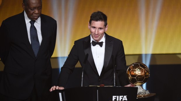 Back on top: Lionel Messi after receiving the Ballon d'Or from acting FIFA President Issa Hayatou.