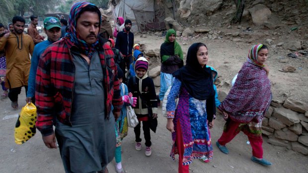 People head back to home following a bomb blast at the shrine of Sufi saint Shah Bilal Noorani in Khuzdar district, Pakistan in November 2016.