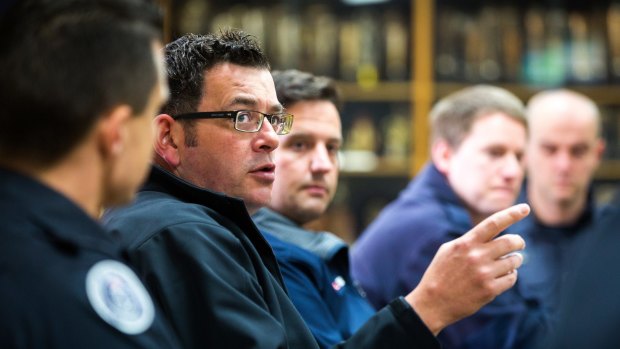 Premier Daniel Andrews in June, pointing out to firefighters how he's fixing things...