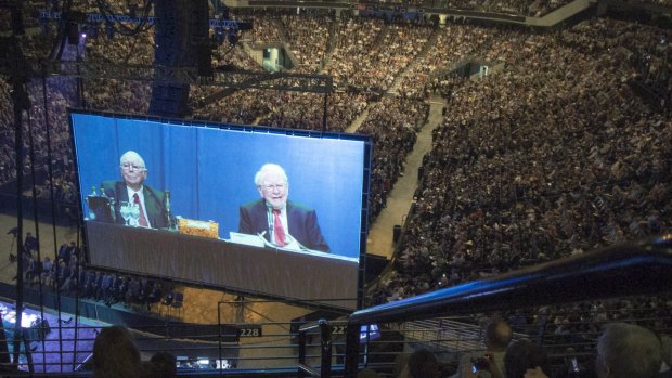 Charlie Munger (left) and Warren Buffett on a giant screen at a Berkshire Hathaway shareholders' meeting.