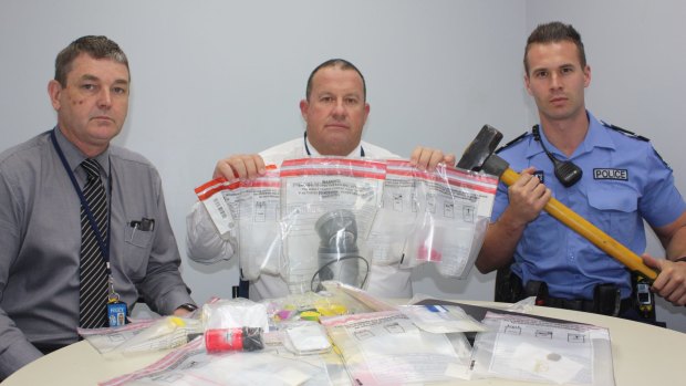 Detectives with some of the material allegedly seized.  