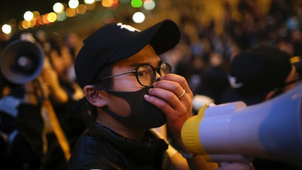 A Chinese immigrant holds a megaphone during a protest in Paris on Thursday.
