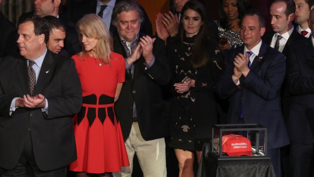 All the president-elect's men: Stephen Bannon, fourth from left, and Reince Priebus, sixth from left,  during Donald Trump's victory speech in New York.