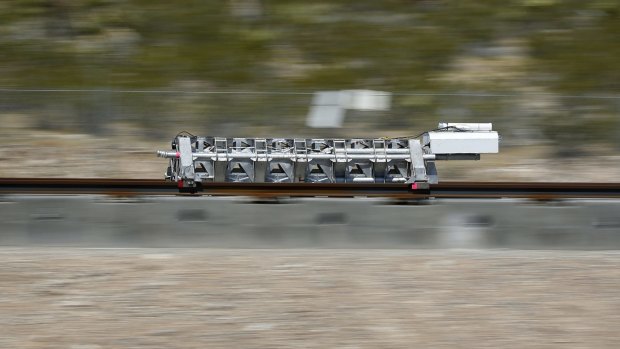 A sled speeds down a track during a test of a Hyperloop One propulsion system in North Las Vegas.