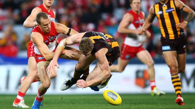 Awkward contact: Swans veteran Ted Richards and Hawthorn's Ben McEvoy.