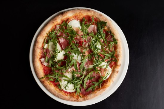 Pizza with tomato, San Daniele prosciutto, rocket and buffalo mozzarella at Tipico, Windsor.