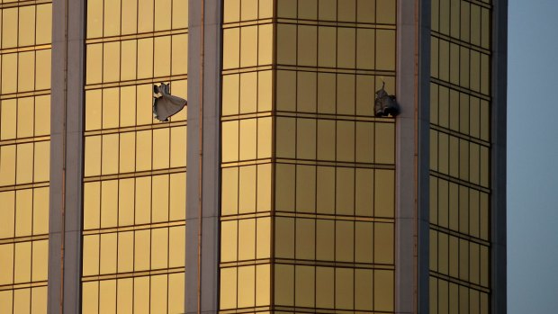 Drapes billow out of broken windows at the Mandalay Bay resort.