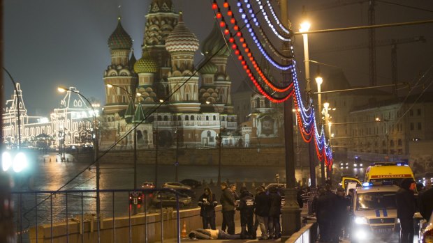 Russian police investigate the the body of Boris Nemtsov, a former Russian deputy prime minister and opposition leader at Red Square with St Basil Cathedral in the background in Moscow, Russia.
