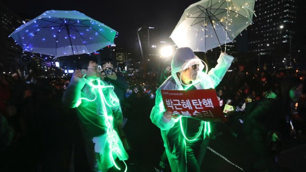 People wearing electronic lights attached to their clothing perform during a rally calling for impeached President Park Geun-hye's arrest in Seoul last week.
