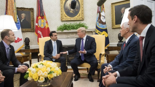 US President Donald Trump, center right, speaks to Ricardo Rossello, governor of Puerto Rico.