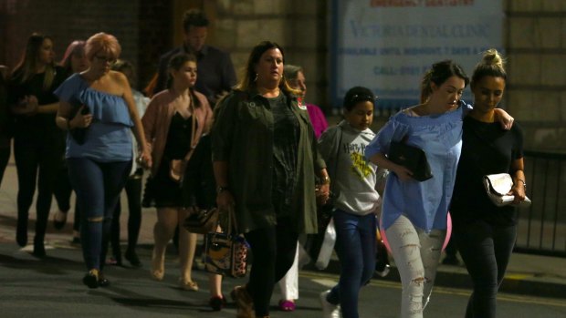 Members of the public are escorted from the Manchester Arena following the blast. 