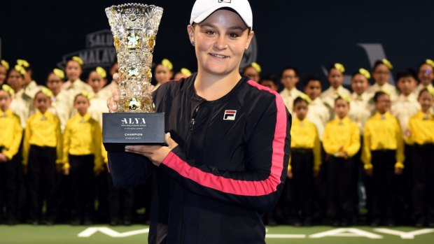 Ashleigh Barty poses with the WTA Malaysian Open Champion Trophy after beating Nao Hibino of Japan.