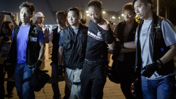 Civic Party member Ken Tsang is taken away by policemen.