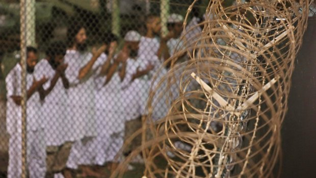 Guantanamo detainees take part in dawn prayers inside the detention centre in 2009. 