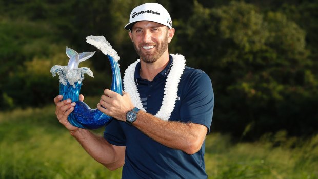 Dustin Johnson poses with the trophy after the final round of the Tournament of Champions.