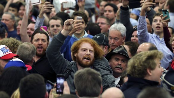 A protester is escorted out of a rally for Republican presidential candidate Donald Trump in Louisville, Kentucky. 