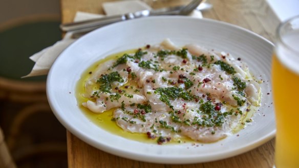 Swordfish carpaccio sprinkled with pink peppercorns and chives.