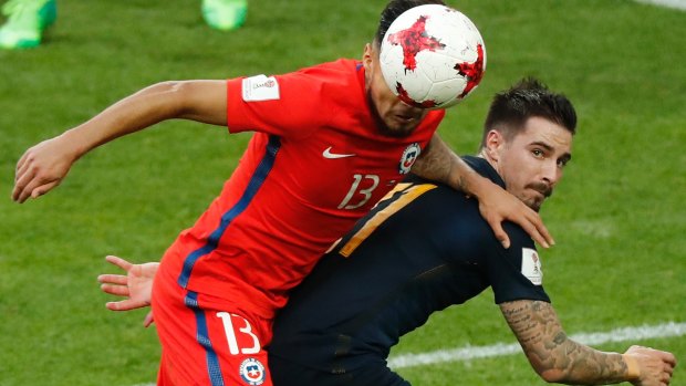 Chile's Paulo Cesar Diaz Huincales  challenges for the ball with Australia's Jamie Maclaren.