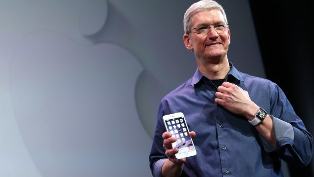 Apple CEO Tim Cook holds the new iPhone 6 Plus.