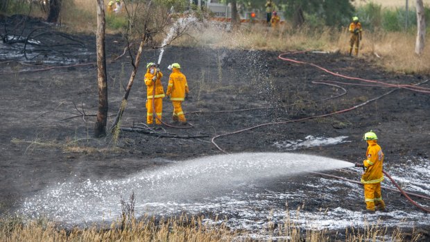 Emergency services mopping up after Umbagong District Park grass fire in Latham which came within 50 metres of homes.