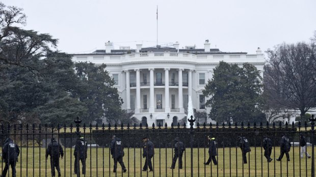 Secret service officers search the grounds of the White House after a small drone was found.