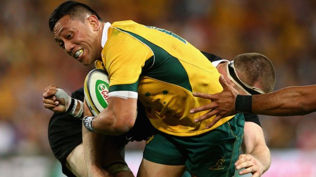 Wallaby force: Christian Leali'ifano is tackled during the Bledisloe Cup match against the All Blacks at Suncorp Stadium.