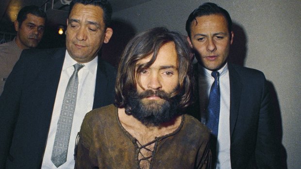 In this 1969 file photo, Charles Manson is escorted to his arraignment on conspiracy-murder charges in connection with the Sharon Tate murder case. 