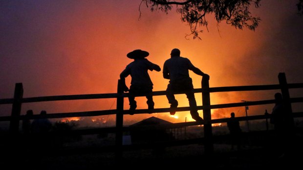 Residents watch the forest burn in Portezuelo, Chile, last week. 