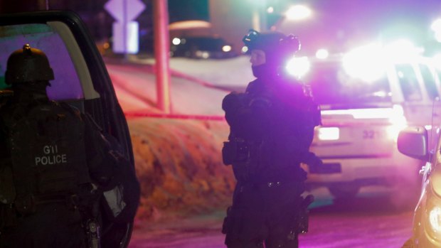 Police survey the scene after a deadly shooting at a mosque in Quebec City, Canada on Sunday.