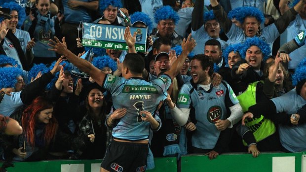 Singing, the Blues: Jarryd Hayne celebrates with Blues fans after NSW won back the origin trophy at ANZ Stadium.