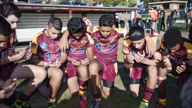 The Guildford Owls Under 14s rugby league team gather in a prayer circle before every game.