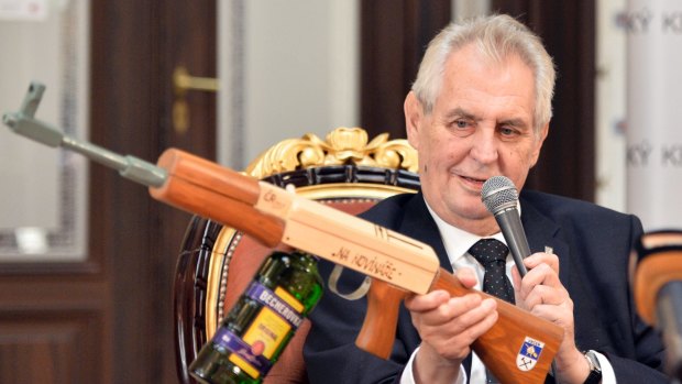 Czech President Milos Zeman holds a mock gun with the inscription "at journalists" at the press conference in Zbiroh, about 65 km southwest of Prague.