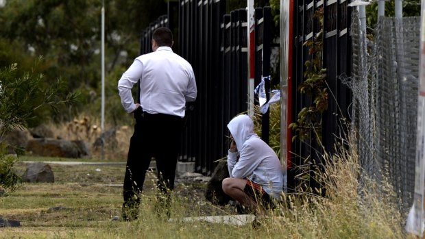 A man talking to police at the scene.