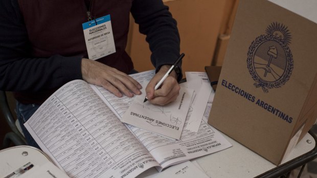 An electoral official certifies voters' envelopes at a polling station in Buenos Aires during the presidential election on Sunday.