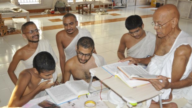 Young monks in Surat studying texts with a senior monk. 