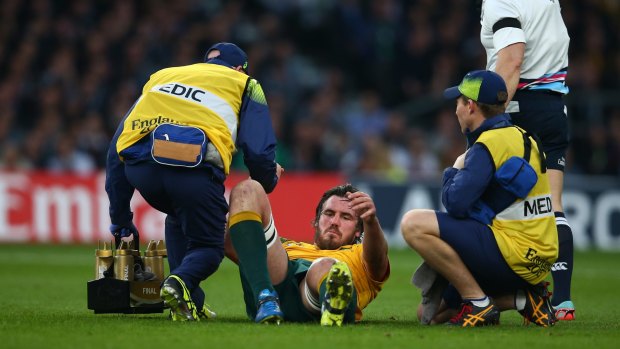 Sour note: Kane Douglas receives treatment for an injury during the 2015 Rugby World Cup final between New Zealand and Australia at Twickenham Stadium.