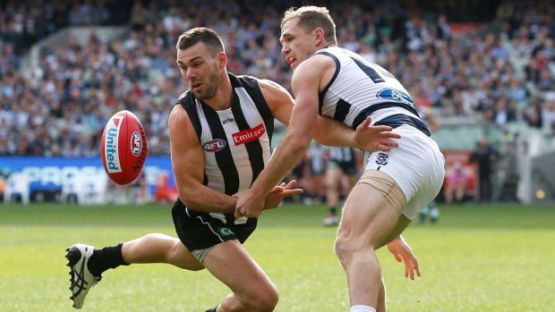 Levi Greenwood of the Magpies and Joel Selwood compete for the ball.