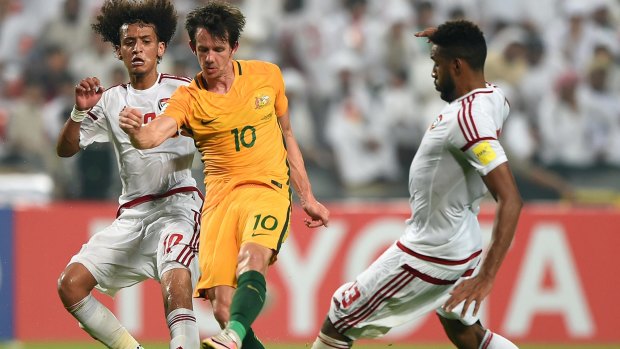 Working hard in the heat: Robbie Kruse gets to the ball first in Abu Dhabi.